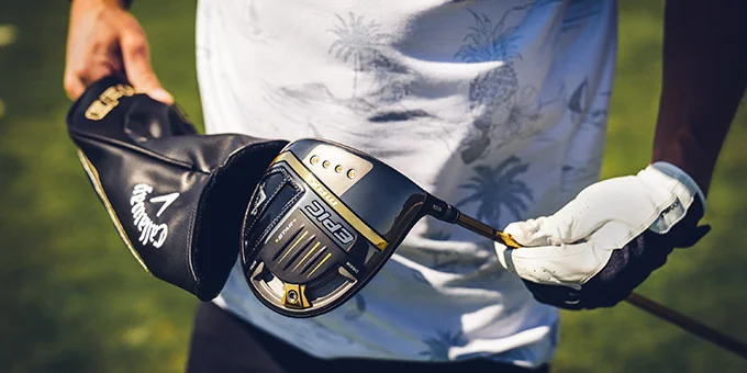 A man holding the Callaway Epic driver with a white glove on his hand.