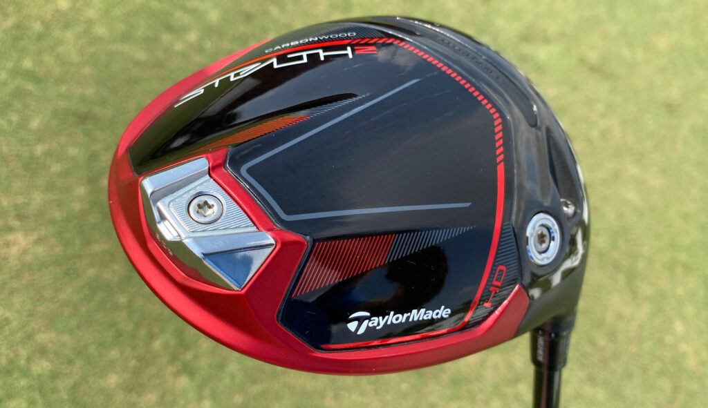 Close-up shot of the  TaylorMade Stealth Driver against green grass.