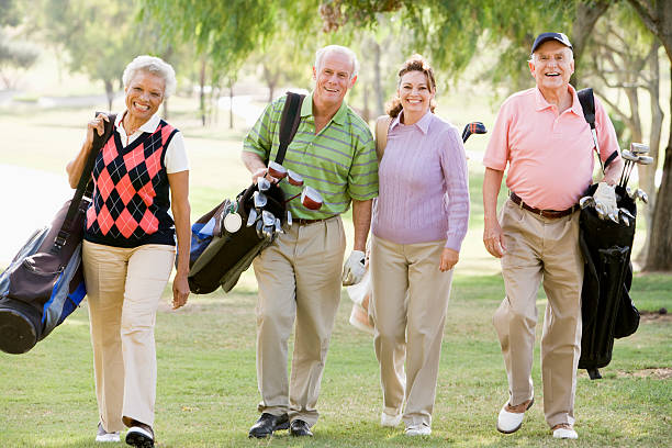 Four Friends Enjoying A Golf Game Walking Across Course